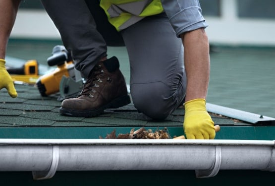 Man Cleaning Gutter